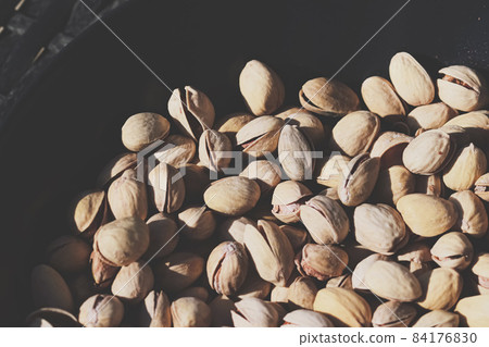 Organic pistachios in the sun, healthy food and snack background Organic pistachios in the sun, healthy food and snack background 84176830