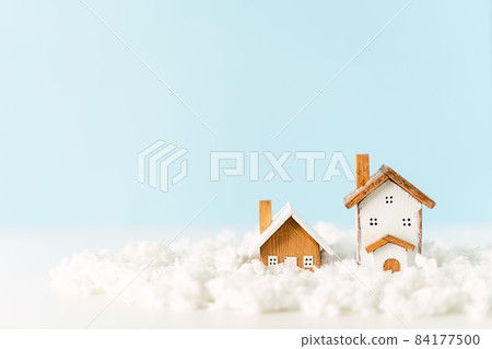 Happy New Year and Merry Christmas banner. Festive blue background with toy wooden house, snow, rustic Christmas village and decoration. Copy space for winter holidays greeting card Happy New Year and Merry Christmas banner. Festive blue background with toy wooden house, snow, rustic Christmas village and decoration. Copy space for winter holidays greeting card 84177500