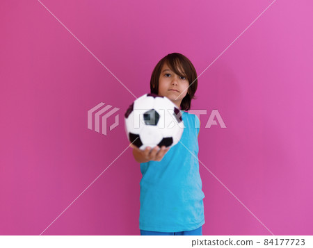 Portrait of young Arabic boy with soccer ball isolated against pink background and copy space 84177723