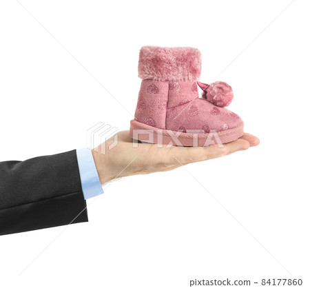 Hand with child shoe Hand with child shoe 84177860