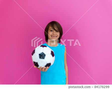Portrait of young Arabic boy with soccer ball isolated against pink background and copy space Portrait of young Arabic boy with soccer ball isolated against pink background and copy space 84178299