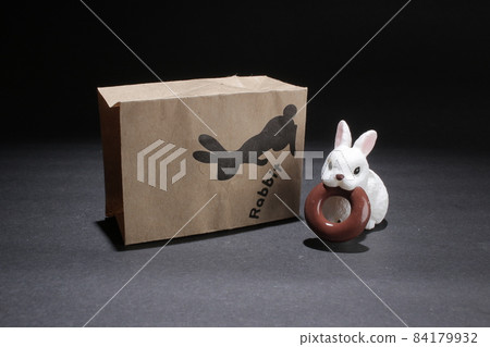 a figure of  rabbit steal the chocolate donut 84179932