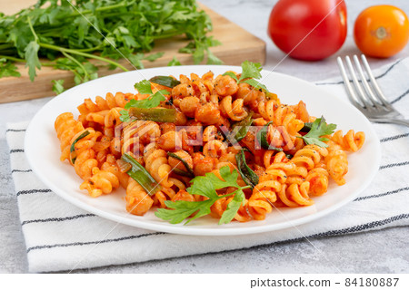 Pasta with tomato sauce, chickpeas and green onions 84180887