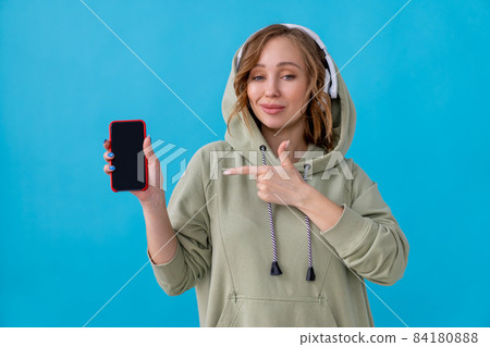 Woman listen music headphones blue background 84180888