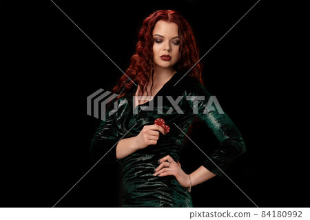 Young beautiful woman with chips in her hands over black. Casino 84180992