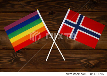 Rainbow flag LGBT and flag of Norway on beautiful brown background with wooden texture. LGBT Pride Month. LGBTQ. LGBTQIA. Human rights concept. Close Up. Top view Rainbow flag LGBT and flag of Norway on beautiful brown background with wooden texture. LGBT Pride Month. LGBTQ. LGBTQIA. Human rights concept. Close Up. Top view 84181707