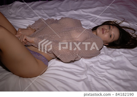 Attractive woman in underwear lying on bed Attractive woman in underwear lying on bed 84182190