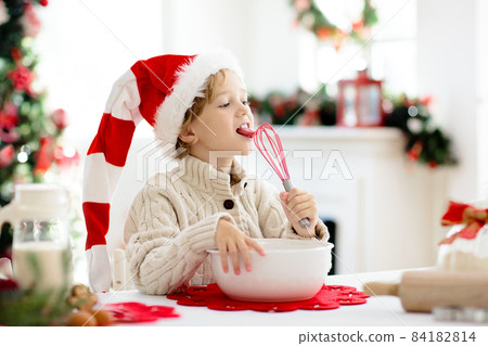 Family baking Christmas cookies. Kids Xmas fun. 84182814