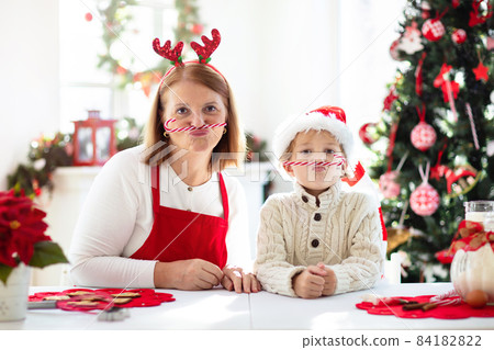 Family baking Christmas cookies. Kids Xmas fun. Family baking Christmas cookies. Kids Xmas fun. 84182822