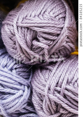 Background from multi-colored fluffy woolen threads for knitting closeup. Background from multi-colored fluffy woolen threads for knitting closeup. 84185215