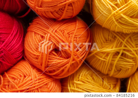 The texture of multi-colored fluffy woolen threads for knitting closeup. The texture of multi-colored fluffy woolen threads for knitting closeup. 84185216