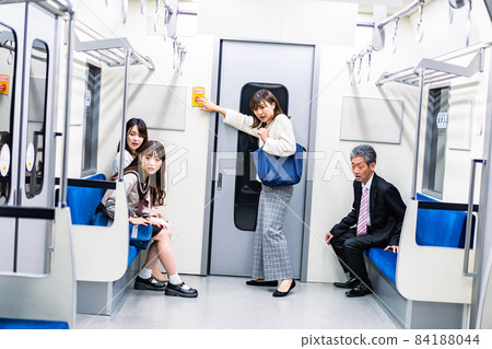 Female pushing the SOS button on the train Female pushing the SOS button on the train 84188044