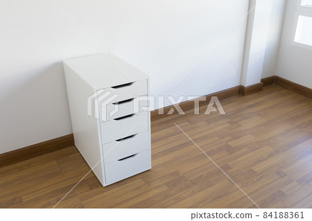 wooden file cabinet on the wooden floor in the white room wooden file cabinet on the wooden floor in the white room 84188361