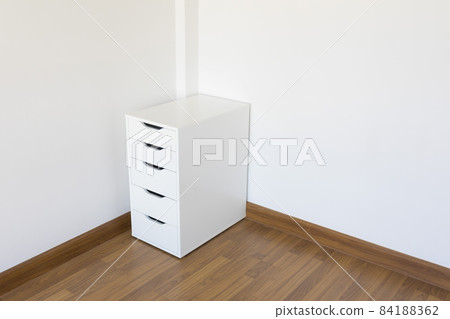 wooden file cabinet on the wooden floor in the white room wooden file cabinet on the wooden floor in the white room 84188362