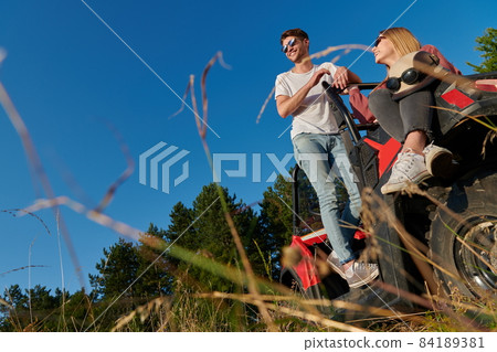 couple enjoying beautiful sunny day while driving a off road buggy couple enjoying beautiful sunny day while driving a off road buggy 84189381