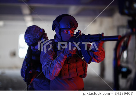 Soldiers squad in tactical formation having action urban environment Soldiers squad in tactical formation having action urban environment 84189407