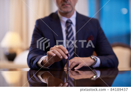 corporate businessman at luxury office pen holding corporate businessman at luxury office pen holding 84189437