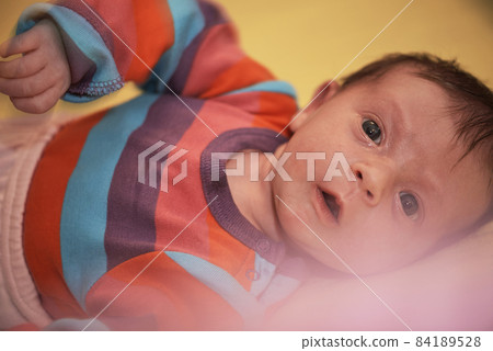One month newborn baby sleeping in bed One month newborn baby sleeping in bed 84189528