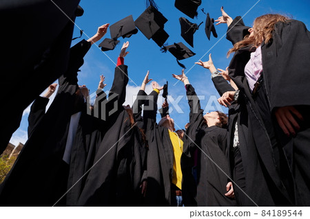 Group of diverse international graduating students celebrating 84189544