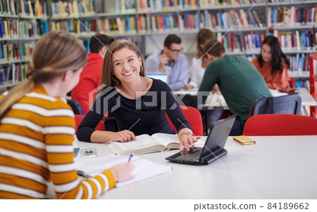 the student uses a notebook and a school library the student uses a notebook and a school library 84189662