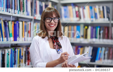 the student uses a notebook and a school library 84189837