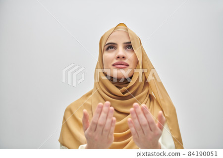 Portrait of young muslim woman making dua, praying to God Portrait of young muslim woman making dua, praying to God 84190051