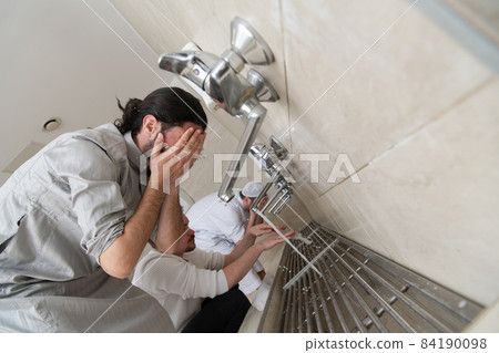 a group of Muslims take ablution for prayer. Islamic religious rite a group of Muslims take ablution for prayer. Islamic religious rite 84190098