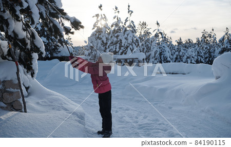 girl throwing fresh snow at beautiful sunny winter day girl throwing fresh snow at beautiful sunny winter day 84190115