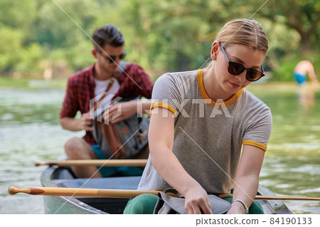 friends are canoeing in a wild river friends are canoeing in a wild river 84190133