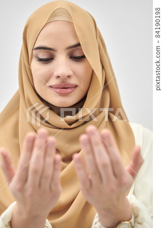 Portrait of young muslim woman making dua, praying to God Portrait of young muslim woman making dua, praying to God 84190198