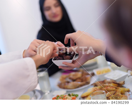 Muslim family having iftar together during Ramadan Muslim family having iftar together during Ramadan 84190299