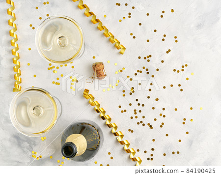 open bottle of champagne and filled glasses of champagne on the festive table, New Year or Christmas celebration concept. Top view. open bottle of champagne and filled glasses of champagne on the festive table, New Year or Christmas celebration concept. Top view. 84190425