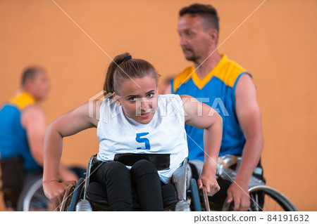 a young woman playing wheelchair basketball in a professional team. Gender equality, the concept of sports with disabilities.  84191632