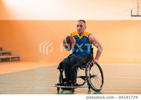 Close up photo of wheelchairs and man with disability playing basketball on the court. Selective focus  84191729