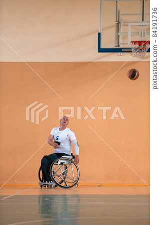 disabled war veterans in action while playing basketball on a basketball court with professional sports equipment for the disabled 84191736