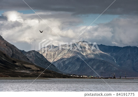 Epic landscape with a small port town on the coast of the Bering Sea Epic landscape with a small port town on the coast of the Bering Sea 84191775