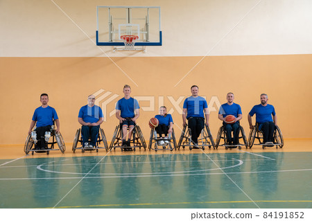 photo of the basketball team of war invalids with professional sports equipment for people with disabilities on the basketball court 84191852