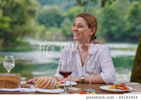 Girlfriend having picnic french dinner party outdoor 84191954