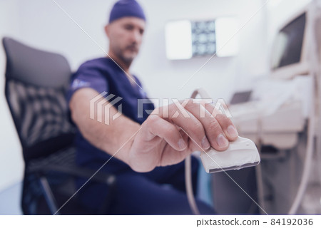 doctor working at the hospital operating ultrasound scanning machine examining knee of her female patient technology modern medicine people vitality concept. doctor working at the hospital operating ultrasound scanning machine examining knee of her female patient technology modern medicine people vitality concept. 84192036
