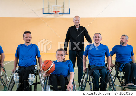 photo of the basketball team of war invalids with professional sports equipment for people with disabilities on the basketball court 84192050