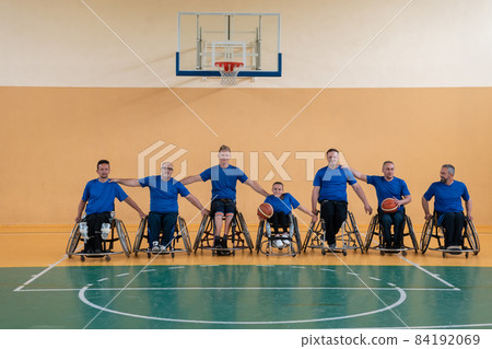 photo of the basketball team of war invalids with professional sports equipment for people with disabilities on the basketball court 84192069