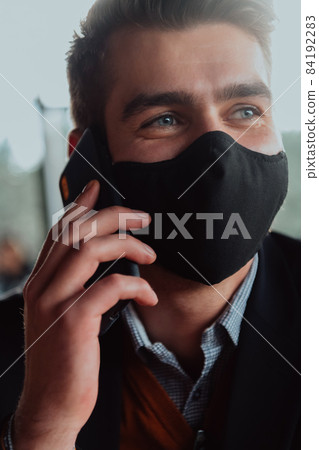 business man wearing protective face mask at office business man wearing protective face mask at office 84192283