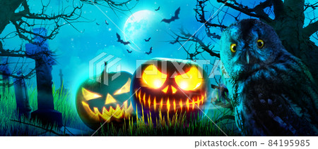 Halloween pumpkin face with burning fire inside in the graveyard. Halloween pumpkin face with burning fire inside in the graveyard. 84195985
