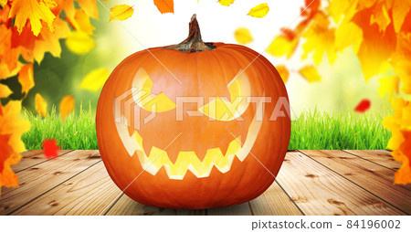 Scary Halloween pumpkin with eyes glowing inside on wooden background Scary Halloween pumpkin with eyes glowing inside on wooden background 84196002