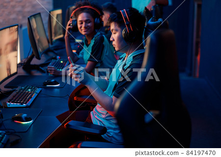 Competitive gamer playes on smartphone in cyber club 84197470