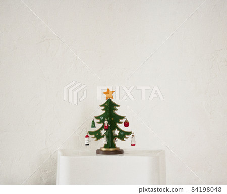 Christmas. A small toy Christmas tree on a white background. Photography. Place for text 84198048