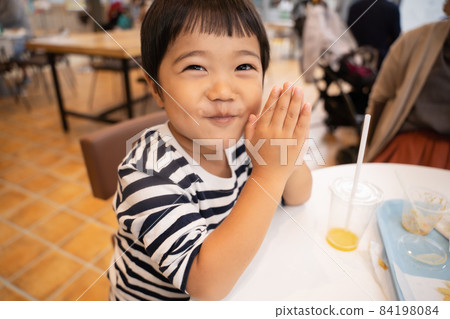 A 4-year-old child who is happy to finish a meal at the food court 84198084