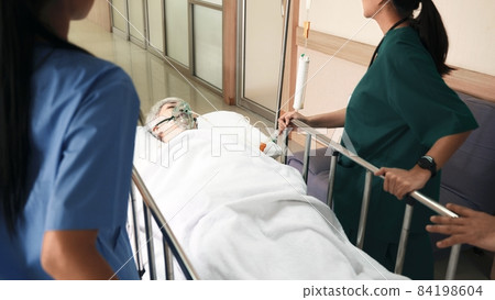 Emergency Department. Nurse and senior doctor team busy push emergency stretcher transport senior patient in hospital 84198604