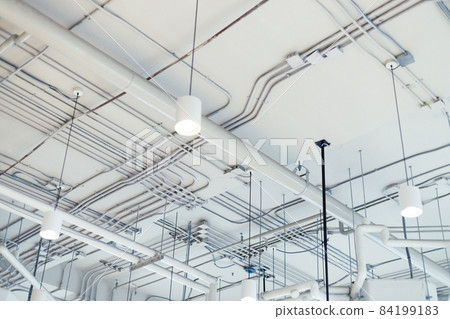 white rustic ceiling background with pipes and conduits 84199183