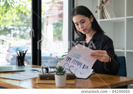 business asian woman working about financial with business report and calculator.financial or accounting concept business asian woman working about financial with business report and calculator.financial or accounting concept 84200088